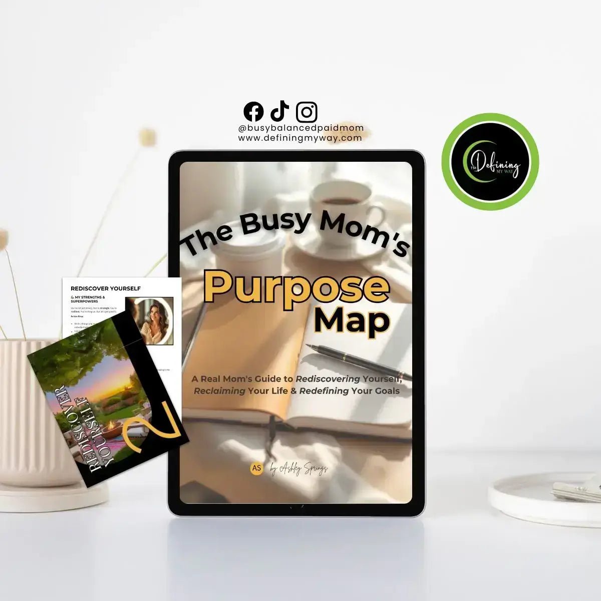 Digital workbook titled 'The Busy Mom's Purpose Map' on a tablet with related materials and a cozy workspace.